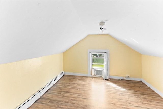 209 S St, Wrentham, MA 02093 - additional living space featuring a baseboard radiator, light wood-style floors, vaulted ceiling, baseboards, and cooling unit