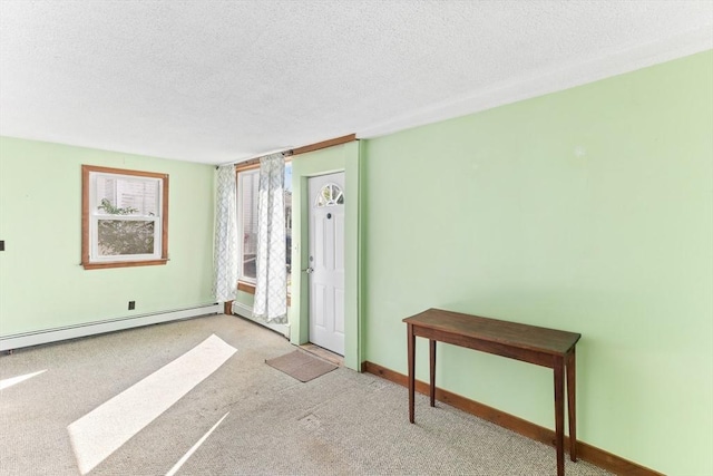 209 S St, Wrentham, MA 02093 - foyer with a textured ceiling, carpet floors, a baseboard heating unit, and baseboards
