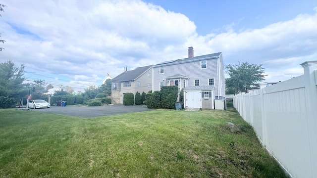 628 Malden St, Revere, MA 02151 - rear view of property with a chimney