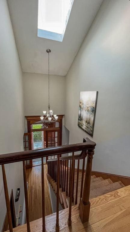 628 Malden St, Revere, MA 02151 - stairway with high vaulted ceiling, a chandelier, and a skylight