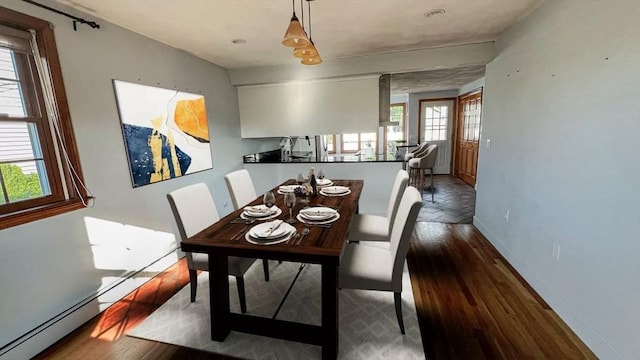 628 Malden St, Revere, MA 02151 - dining area with plenty of natural light, baseboards, wood finished floors, and baseboard heating