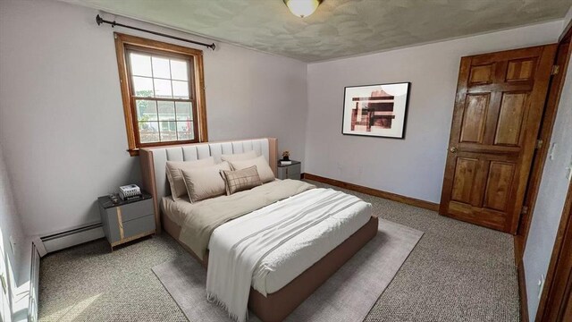 628 Malden St, Revere, MA 02151 - bedroom with baseboard heating, light carpet, baseboards, and a textured ceiling