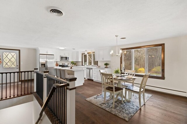 126 Prospect Hill St, Taunton, MA 02780 - dining space featuring dark wood-style flooring, a chandelier, and baseboard heating