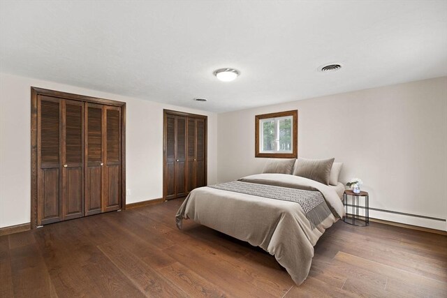 126 Prospect Hill St, Taunton, MA 02780 - bedroom with dark wood-type flooring, two closets, a baseboard radiator, and baseboards