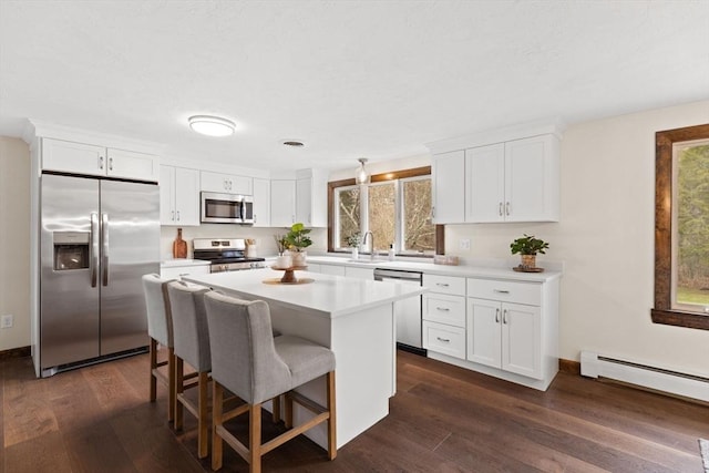 126 Prospect Hill St, Taunton, MA 02780 - kitchen with appliances with stainless steel finishes, a center island, healthy amount of natural light, and white cabinets