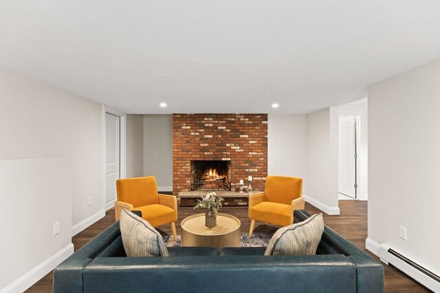 126 Prospect Hill St, Taunton, MA 02780 - living room with a baseboard radiator, a brick fireplace, dark wood-style flooring, baseboards, and recessed lighting