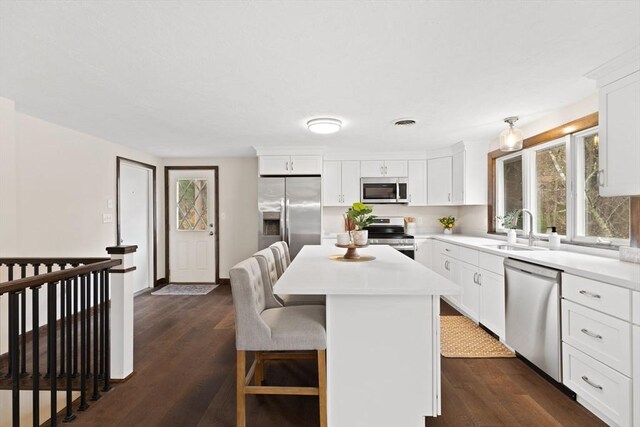 126 Prospect Hill St, Taunton, MA 02780 - kitchen with appliances with stainless steel finishes, a sink, a breakfast bar, light countertops, and a center island