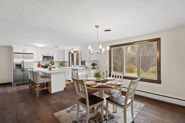 126 Prospect Hill St, Taunton, MA 02780 - dining space with dark wood-style floors, a chandelier, a baseboard radiator, and a textured ceiling
