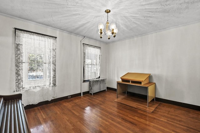 interior space with dark wood-type flooring, radiator heating unit, a healthy amount of sunlight, and ornamental molding