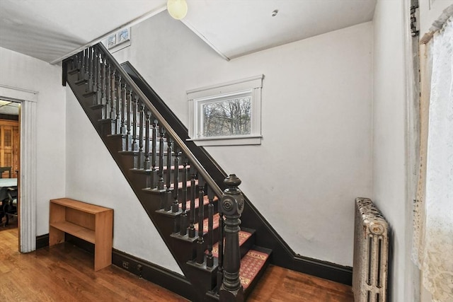 stairway featuring hardwood / wood-style floors and radiator