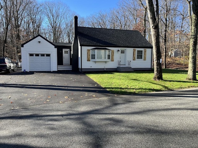 single story home with a garage and a front lawn