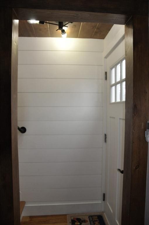 mudroom with wood walls