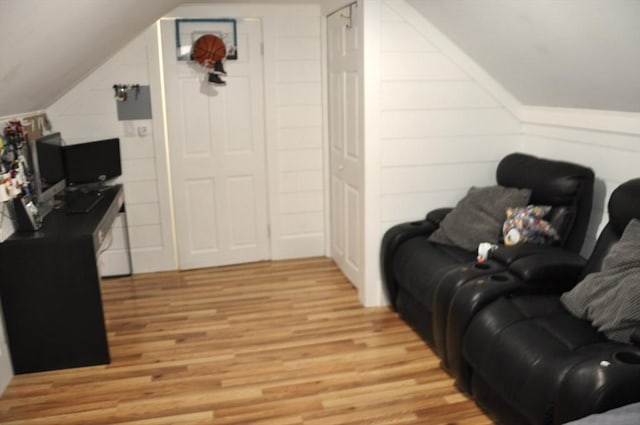 living room with lofted ceiling and light hardwood / wood-style flooring