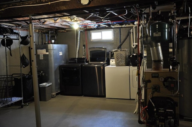 basement with water heater and washing machine and dryer