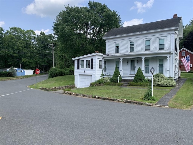 293 Washington, Warren, MA 01083 - multi unit property featuring a chimney, covered porch, a garage, a front yard, and driveway