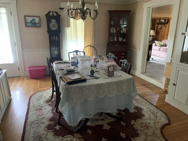 293 Washington, Warren, MA 01083 - dining space with a chandelier, healthy amount of natural light, a wainscoted wall, light wood-style flooring, and ornamental molding