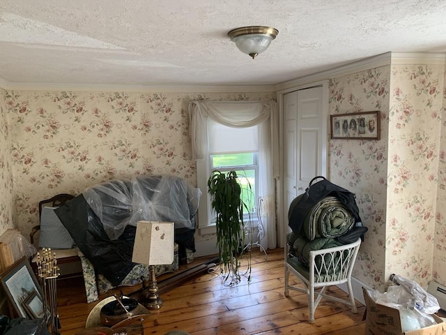 293 Washington, Warren, MA 01083 - sitting room with a textured ceiling, wallpapered walls, and hardwood / wood-style flooring