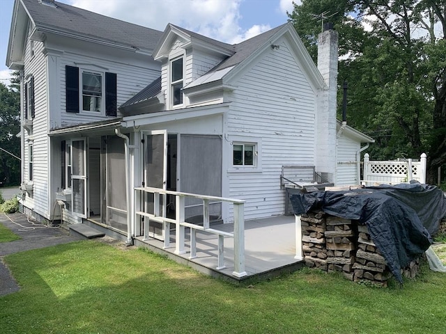 293 Washington, Warren, MA 01083 - back of property featuring a sunroom, a chimney, and a yard