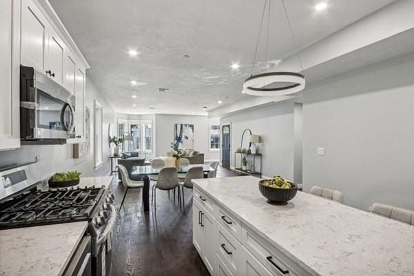 kitchen featuring light stone countertops, white cabinets, and appliances with stainless steel finishes