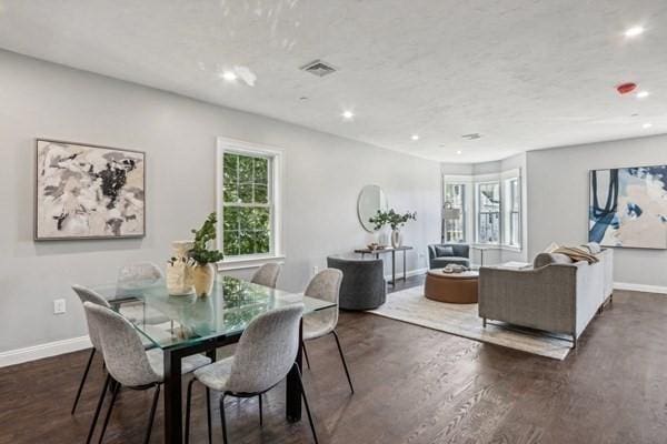 dining space featuring dark hardwood / wood-style flooring