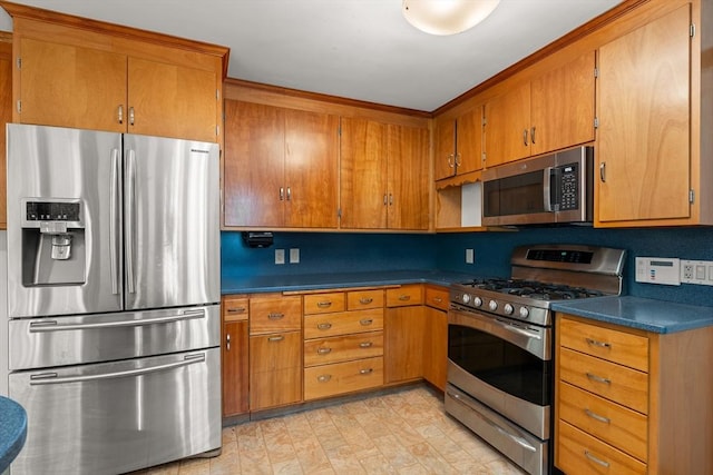 4 Farmland Rd, Saugus, MA 01906 - kitchen featuring stainless steel appliances, brown cabinets, and dark countertops