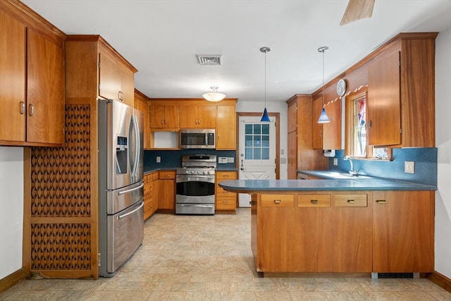 4 Farmland Rd, Saugus, MA 01906 - kitchen with appliances with stainless steel finishes, a sink, a peninsula, brown cabinets, and dark countertops
