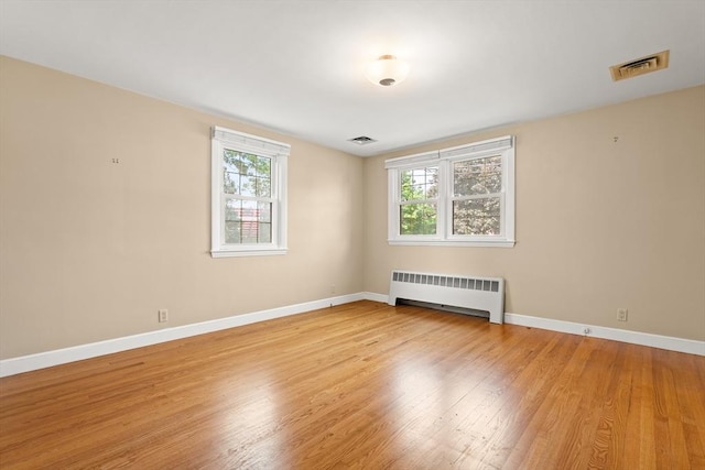 4 Farmland Rd, Saugus, MA 01906 - spare room featuring radiator heating unit, wood finished floors, and baseboards
