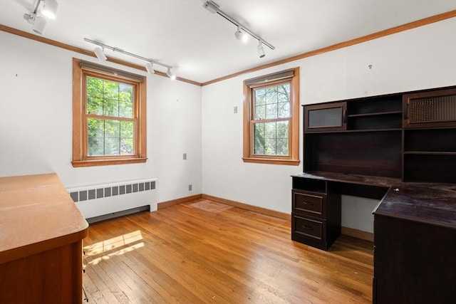 4 Farmland Rd, Saugus, MA 01906 - unfurnished office featuring radiator heating unit, rail lighting, ornamental molding, light wood-type flooring, and baseboards