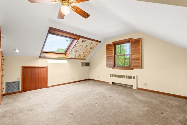 4 Farmland Rd, Saugus, MA 01906 - bonus room with radiator heating unit, vaulted ceiling, carpet floors, baseboards, and a skylight