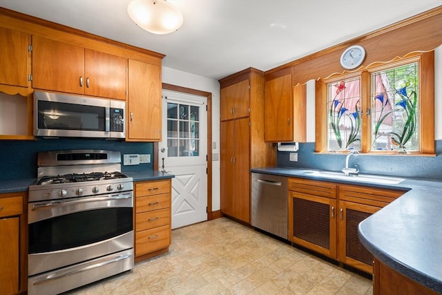 4 Farmland Rd, Saugus, MA 01906 - kitchen with appliances with stainless steel finishes, a sink, dark countertops, and brown cabinets