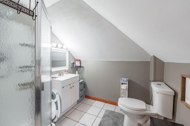 bathroom featuring lofted ceiling, vanity, toilet, a shower with door, and tile patterned floors