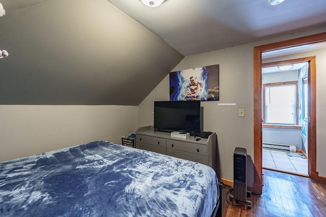 bedroom featuring wood-type flooring, lofted ceiling, and baseboard heating