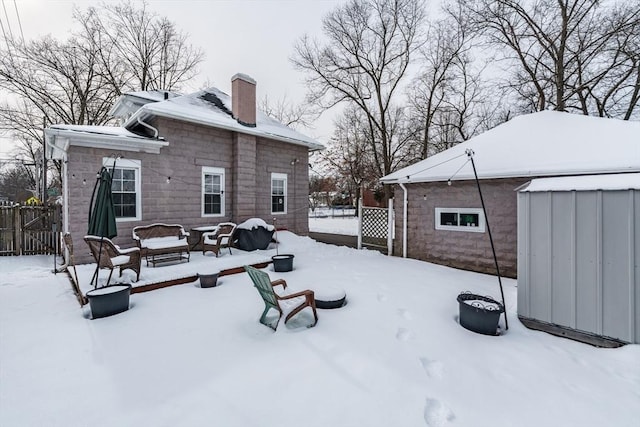 view of snow covered rear of property