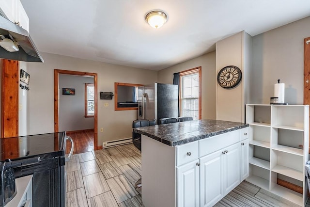 kitchen featuring white cabinets and baseboard heating