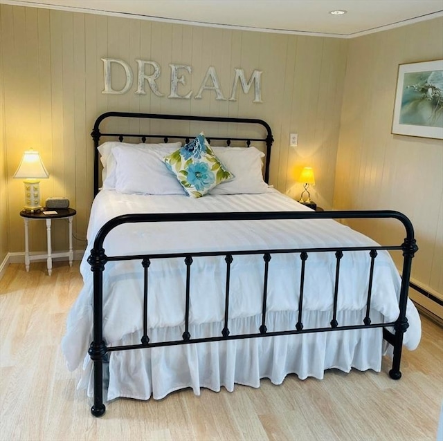 bedroom featuring wood walls and hardwood / wood-style floors