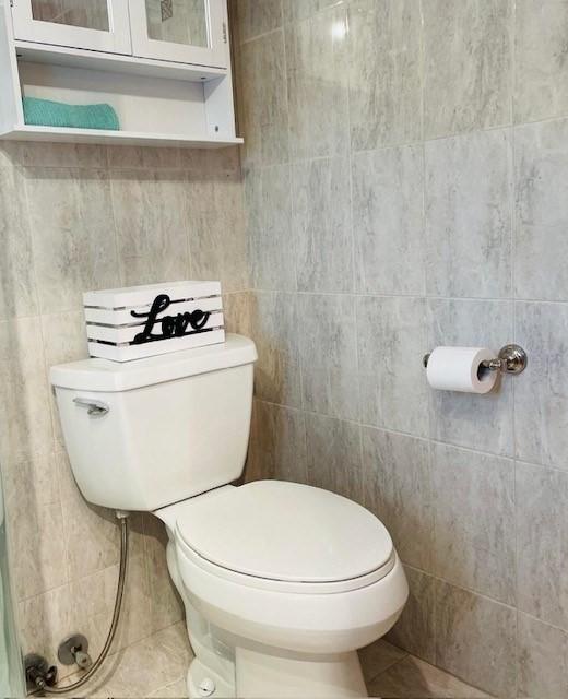 bathroom with tile patterned flooring and toilet