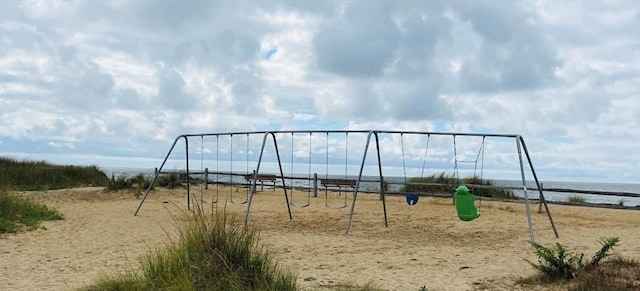 view of jungle gym with a water view