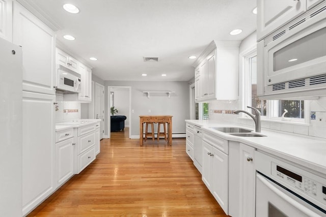 1 Pleasantview Ter, Framingham, MA 01701 - kitchen featuring white appliances, a sink, backsplash, light wood finished floors, and recessed lighting