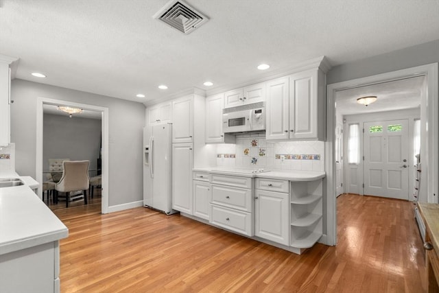 1 Pleasantview Ter, Framingham, MA 01701 - kitchen with white appliances, light wood-style floors, white cabinetry, light countertops, and recessed lighting