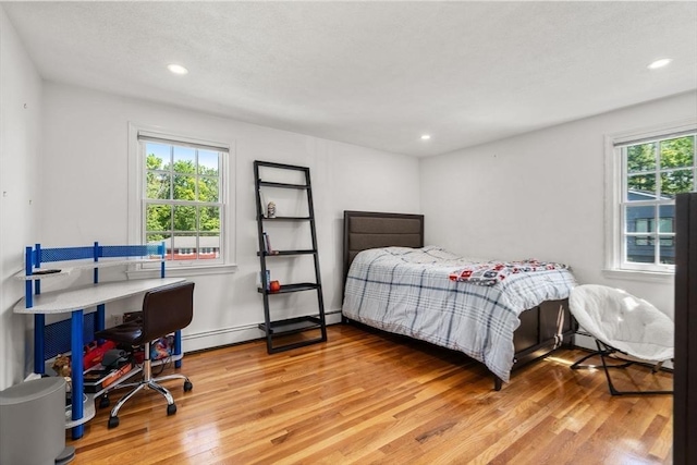 1 Pleasantview Ter, Framingham, MA 01701 - bedroom with light wood-style flooring, recessed lighting, and a baseboard heating unit