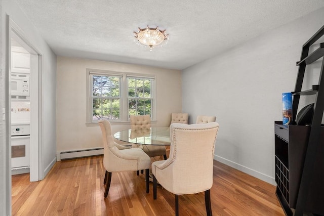 1 Pleasantview Ter, Framingham, MA 01701 - dining space with a baseboard radiator, light wood-type flooring, baseboards, and a textured ceiling