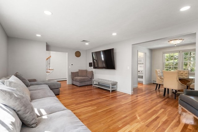 1 Pleasantview Ter, Framingham, MA 01701 - living area featuring light wood finished floors, recessed lighting, stairway, baseboards, and a baseboard radiator