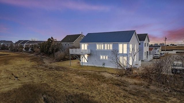 view of back house at dusk