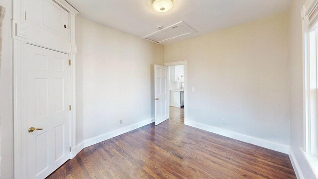 unfurnished bedroom with dark hardwood / wood-style floors