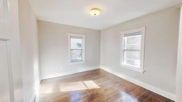 unfurnished room with wood-type flooring