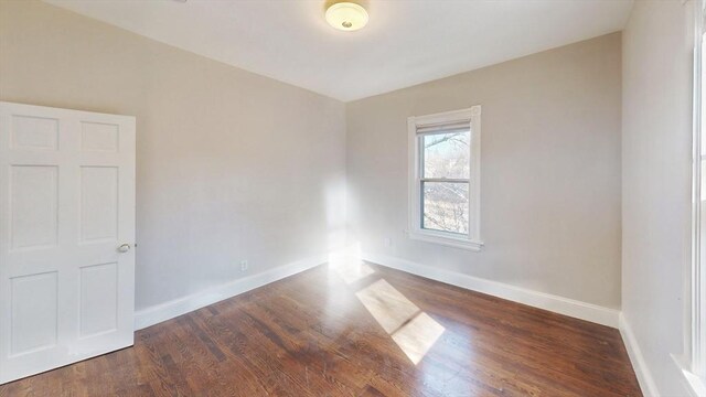 empty room featuring dark hardwood / wood-style flooring