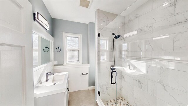 bathroom featuring vanity and a shower with shower door