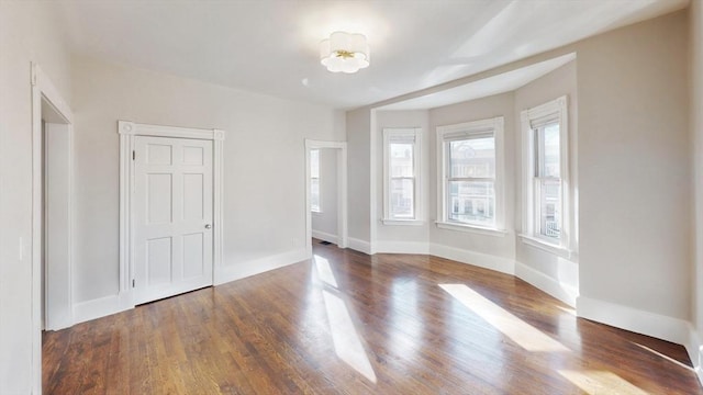 unfurnished bedroom with dark hardwood / wood-style floors