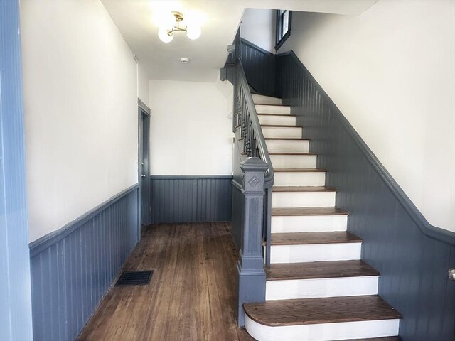 staircase with hardwood / wood-style floors