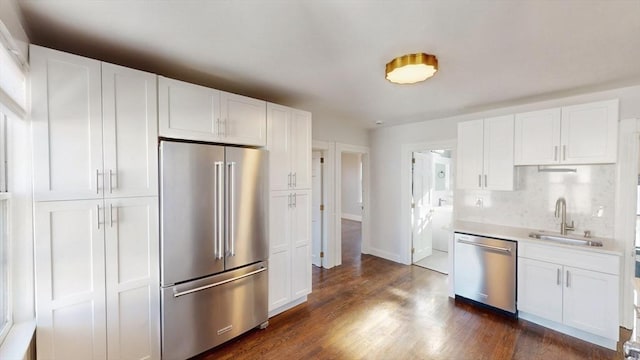 kitchen featuring sink, white cabinets, dark hardwood / wood-style floors, and appliances with stainless steel finishes